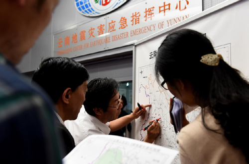 5月18日凌晨，工作人員在云南地震災害應急指揮中心確認震中在地圖上的位置。